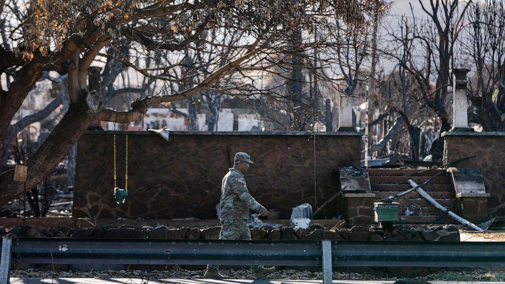 PHOTO: A National Guardsman walks past a home destroyed in a wildfire in Lahaina, Hawaii, Aug. 18, 2023.