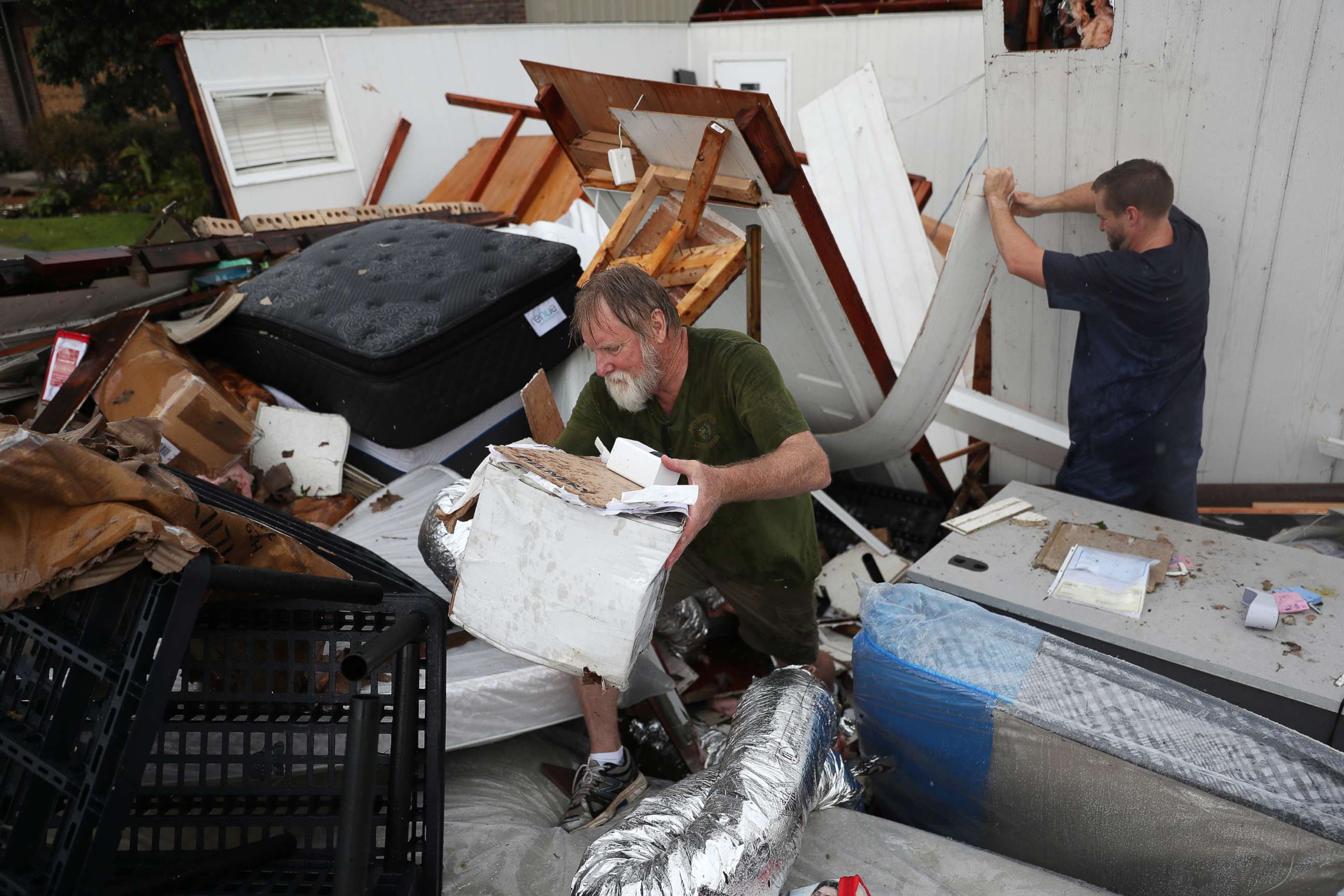 PHOTO:  Butch Segura and his son Stew Segura salvage what they can from their store after  it was destroyed as Hurricane Laura passed through Lake Charles, La., Aug. 28, 2020.
