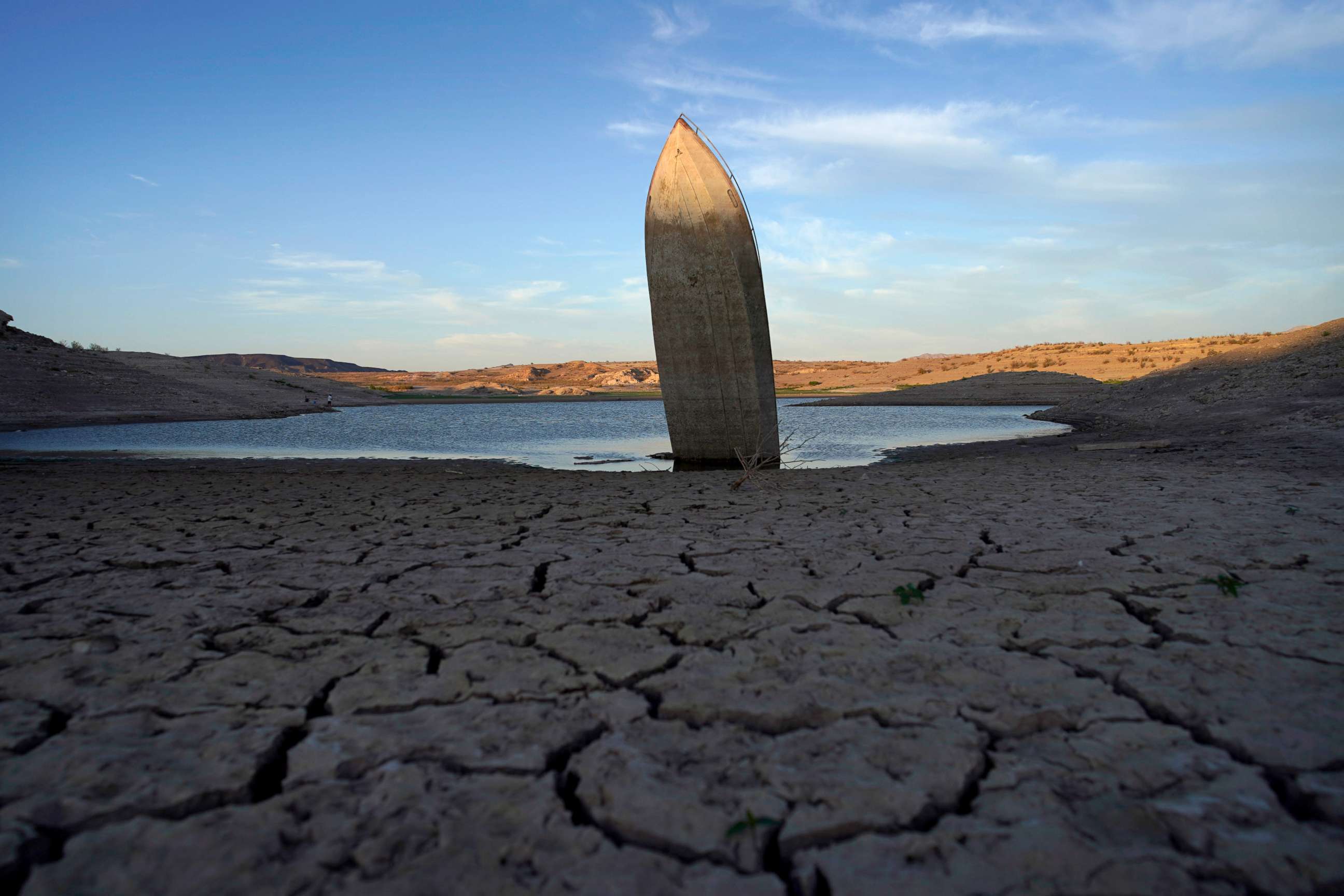 PHOTO: A formerly sunken boat sits upright into the air with its stern stuck in the mud along the shoreline of Lake Mead at the Lake Mead National Recreation Area, June 10, 2022, near Boulder City, Nev.