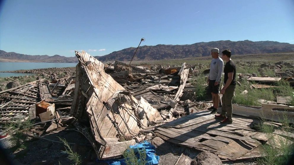 PHOTO: DJ Jenner and ABC News' Matt Gutman observe a wrecked boat that was found after Lake Mead's water level dramatically decreased.