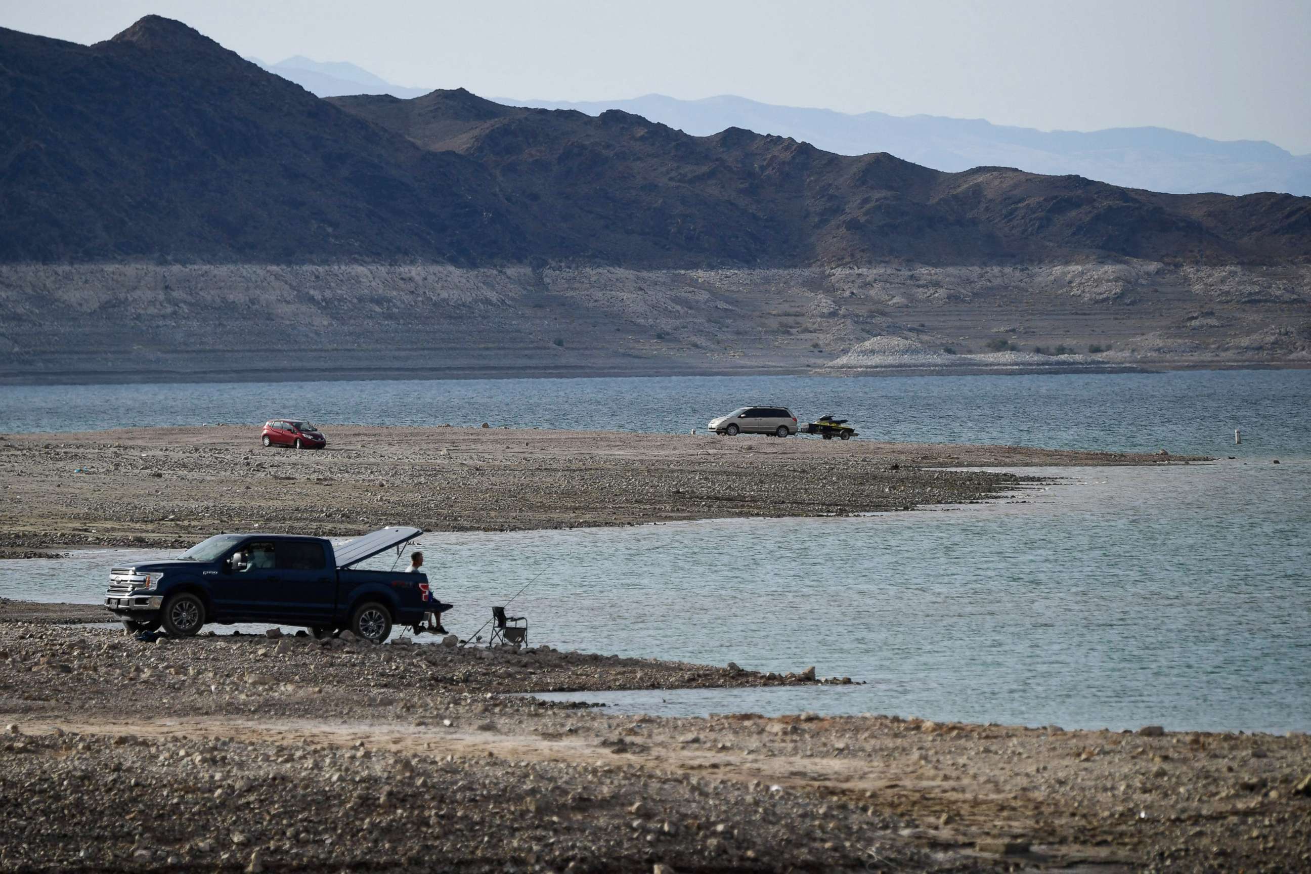 PHOTO: People recreate on the shore during low water levels due to the western drought at the Lake Mead Marina on the Colorado River in Boulder City, Nevada on May 5, 2022.