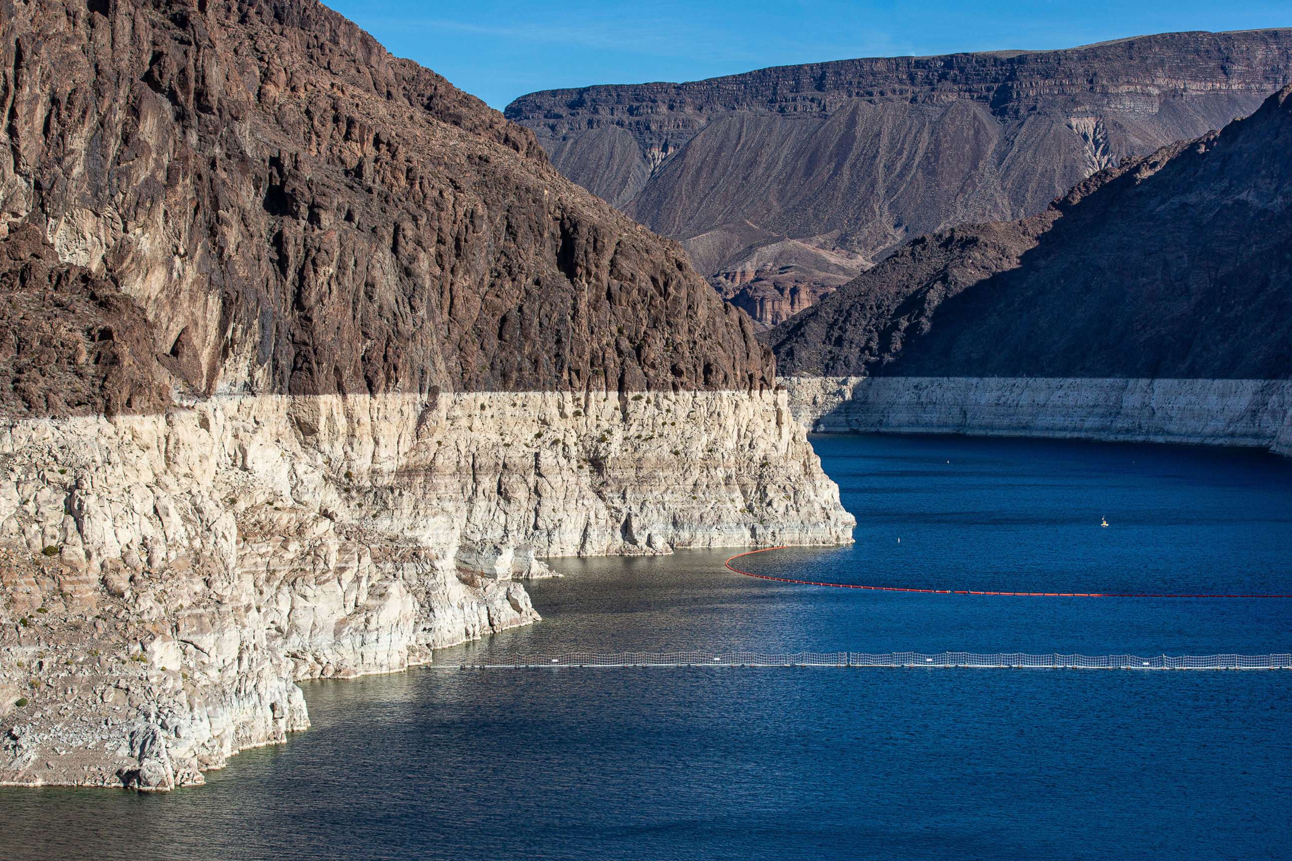 PHOTO: In this Jan. 11, 2022, file photo, a "bathtub ring" caused by the drought has formed in the canyon near the massive concrete Hoover Dam, creating Lake mead on the Colorado River, near Boulder City, Nev.