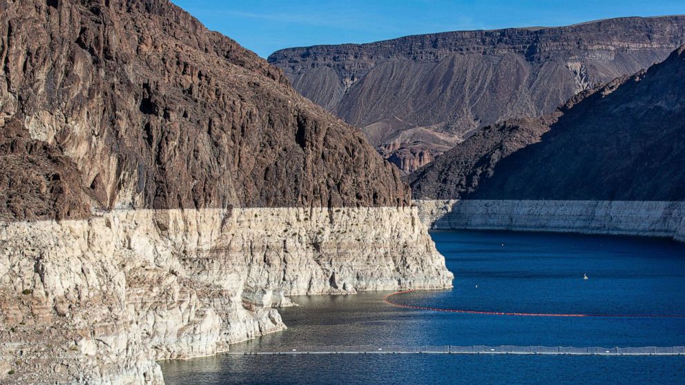 PHOTO: In this Jan. 11, 2022, file photo, a "bathtub ring" caused by the drought has formed in the canyon near the massive concrete Hoover Dam, creating Lake mead on the Colorado River, near Boulder City, Nev.