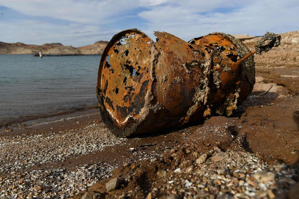 PHOTO: A rusted metal barrel, near the location of where a different barrel was found containing  a human body, sits exposed on shore during low water levels at the Lake Mead Marina on the Colorado River in Boulder City, Nevada on May 5, 2022.