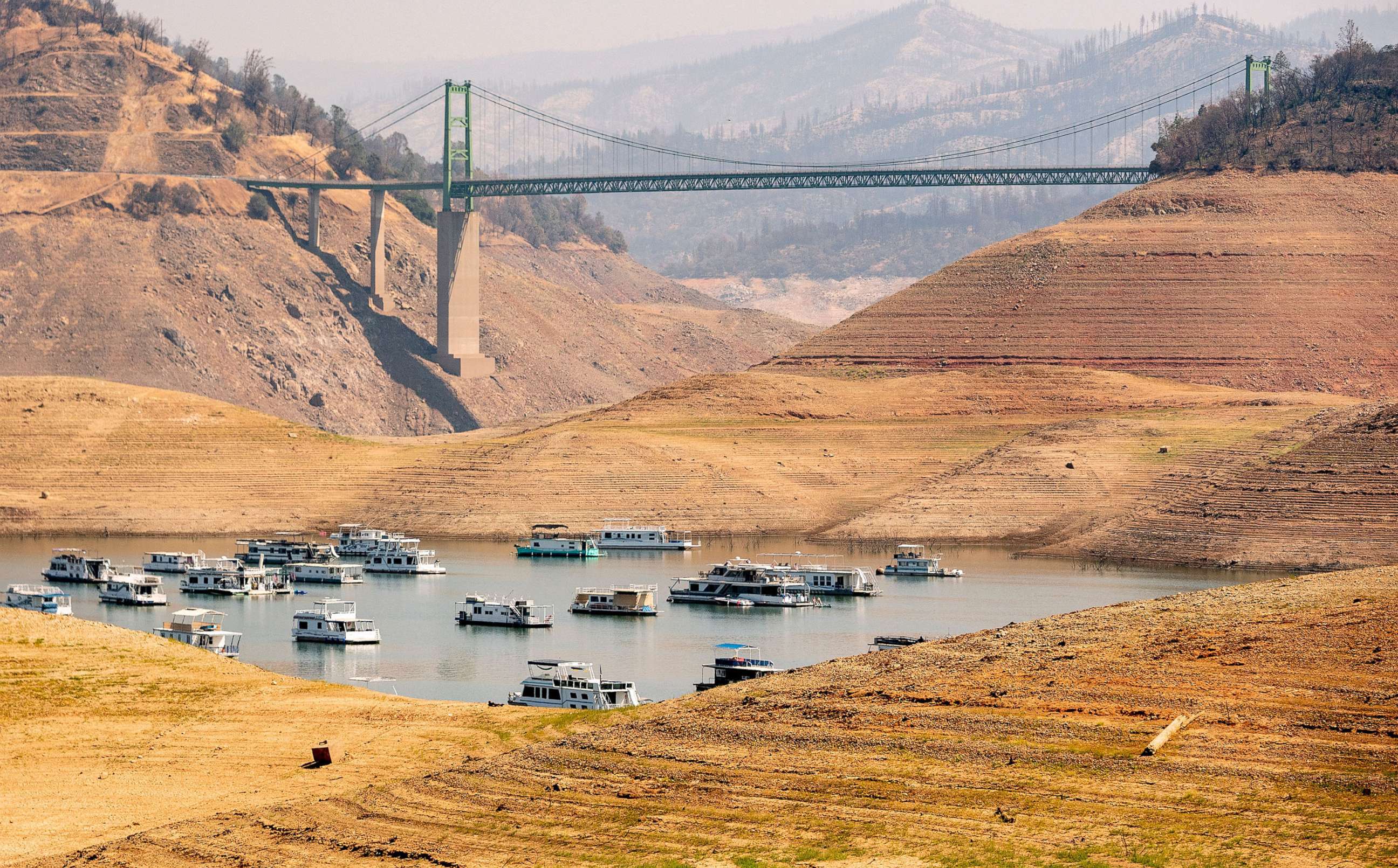 PHOTO: In this Sept. 5, 2021, file photo, houseboats sit in a narrow section of water in a depleted Lake Oroville, in Oroville, Calif.