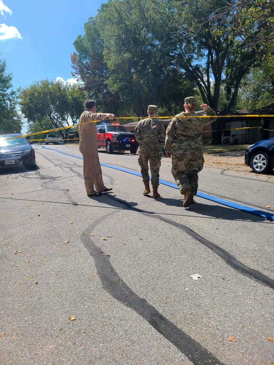 PHOTO: Military personnel walks near the site where a military training aircraft crashed into a residential neighborhood in Lake Worth, Texas, Sept. 19, 2021.