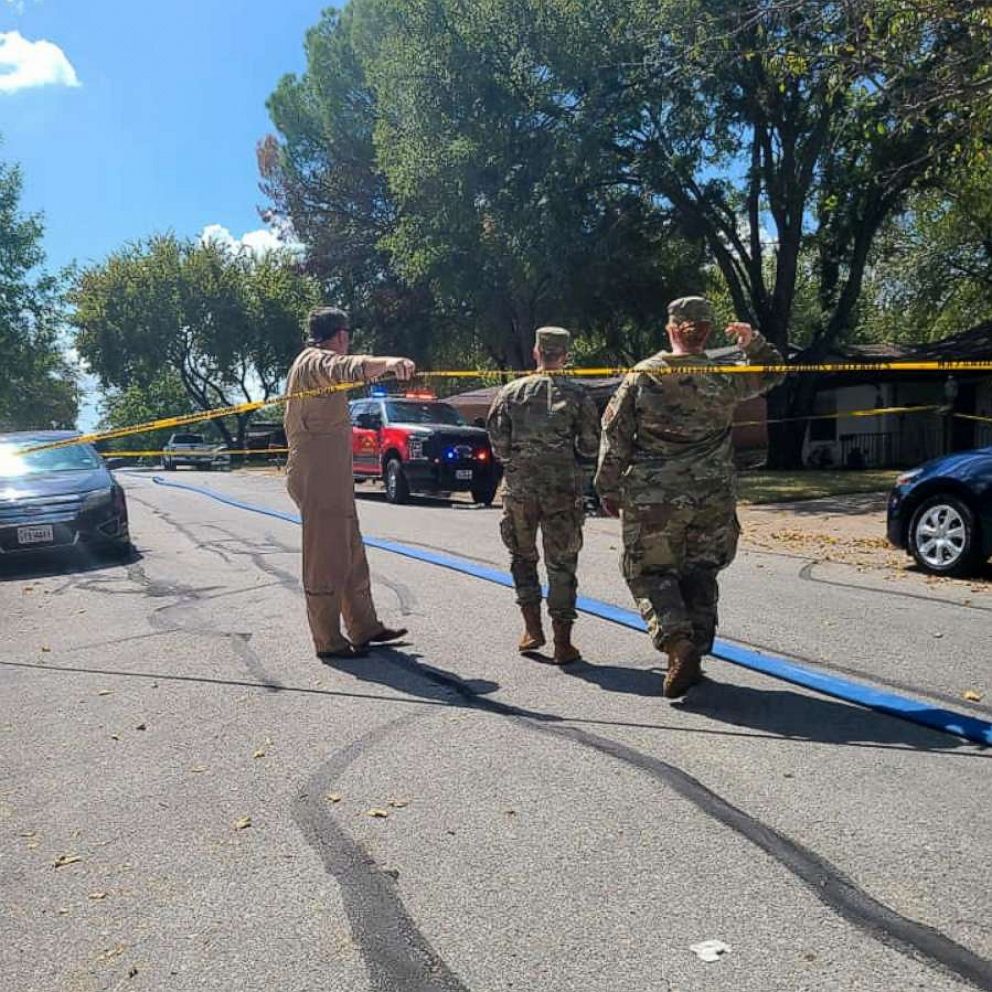 PHOTO: Military personnel walks near the site where a military training aircraft crashed into a residential neighborhood in Lake Worth, Texas, Sept. 19, 2021.