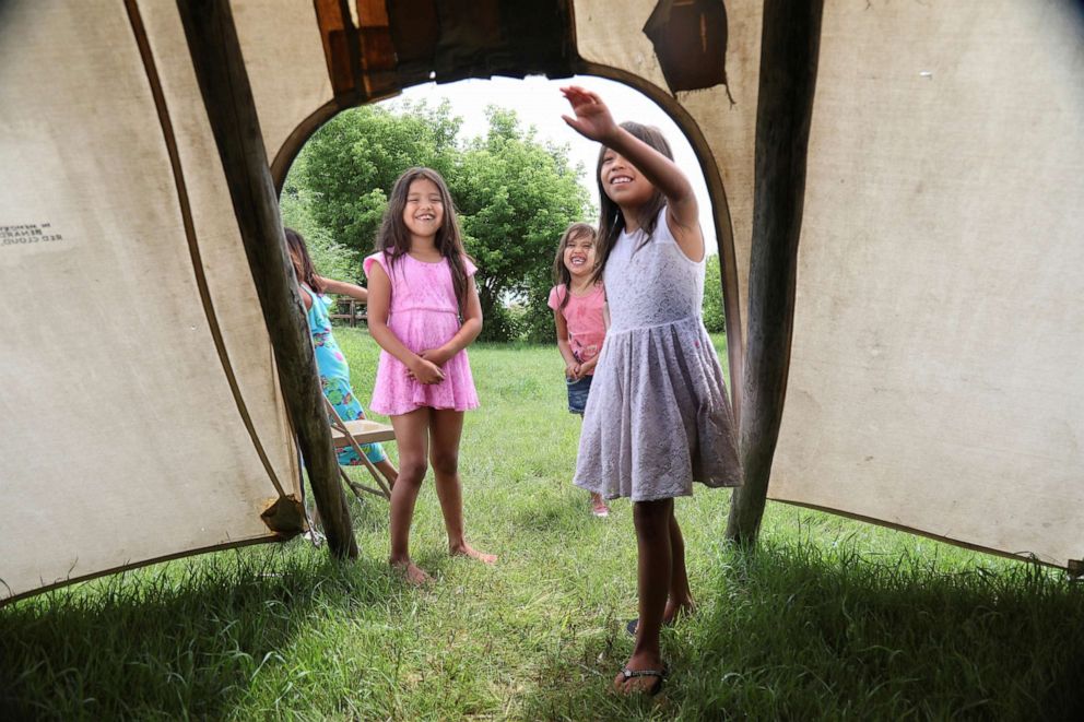 PHOTO: Henry Red Cloud's granddaughters play in a teepee on the  Pine Ridge reservation in South Dakota, June 24, 2018. 