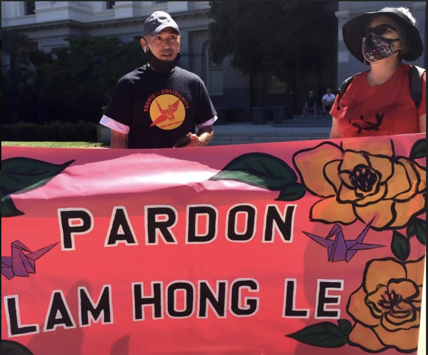 PHOTO: Lam Le stands by a sign at a rally organized by Tsuru for Solidarity on June 4, 2021, in Sacramento, Calif.
