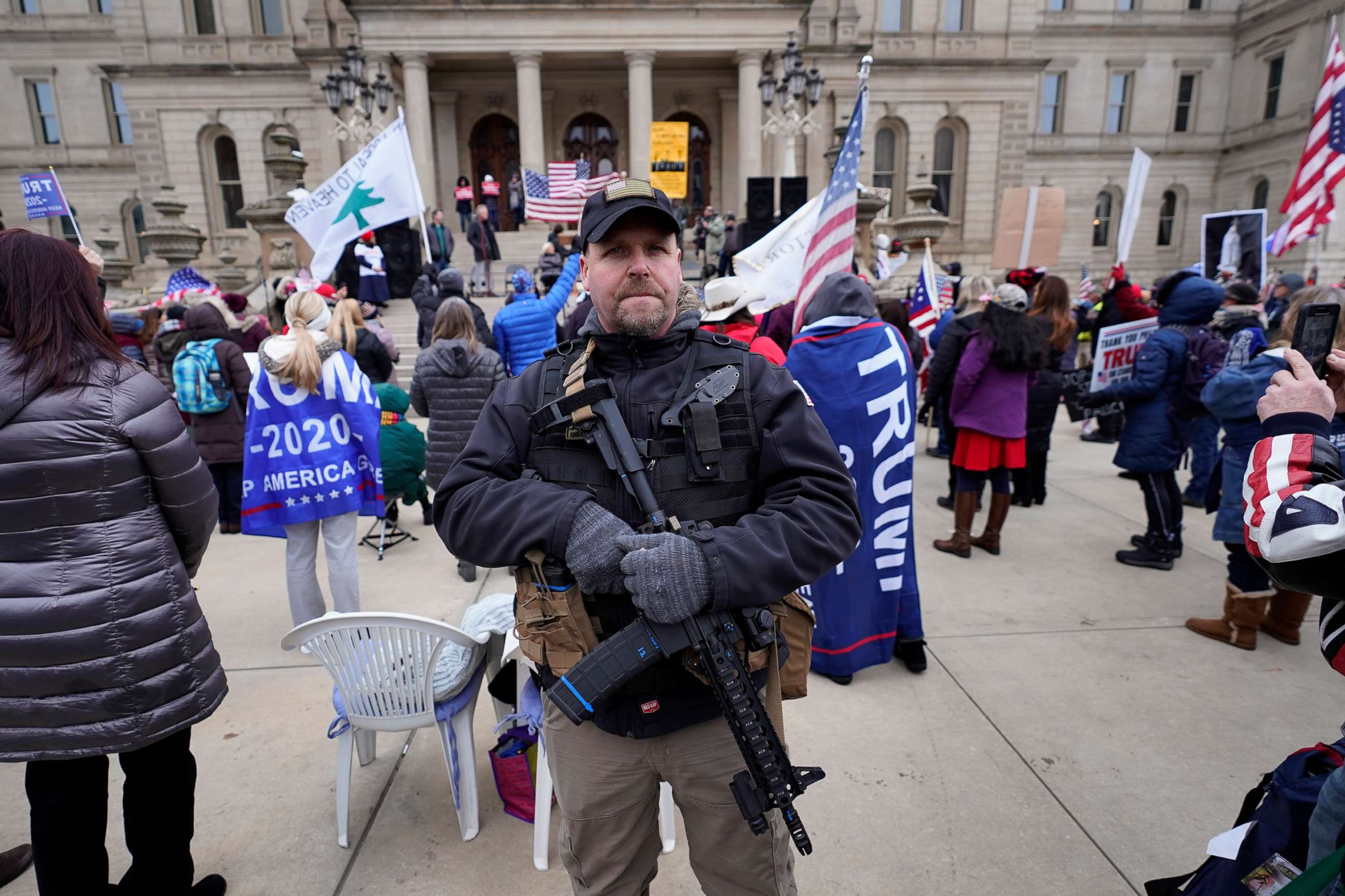 PHOTO: A man carries a rifle during a rally in support of President Donald Trump at the state capitol in Lansing, Mich., Jan. 6, 2021.