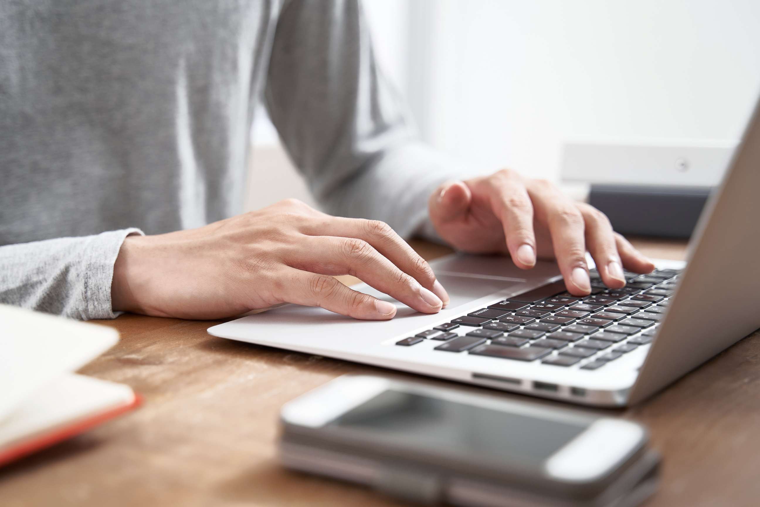 PHOTO: Man typing on a laptop.