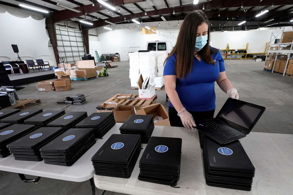 PHOTO: Chief Executive Officer Megan Steckly readies computers to be distributed at Comp-U-Dopt, April 14, 2020, in Houston. 