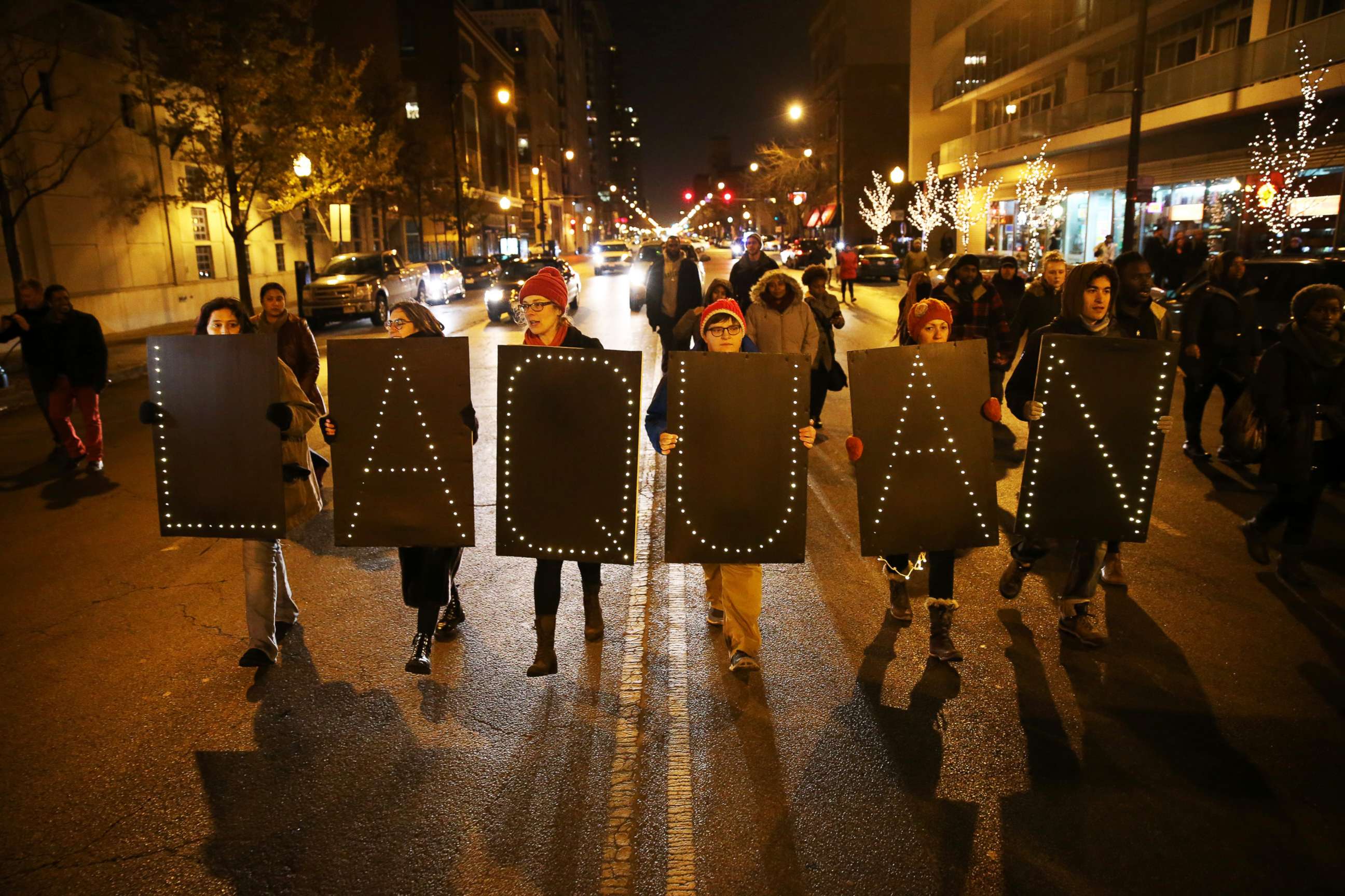 PHOTO: Protesters form a line and walk holding signs that spell out "Laquan" following the release of a dash-cam video of 17-year-old Laquan McDonald being fatally shot 16 times by Chicago Police officer Jason Van Dyke, on Nov. 24 2015, in Chicago.