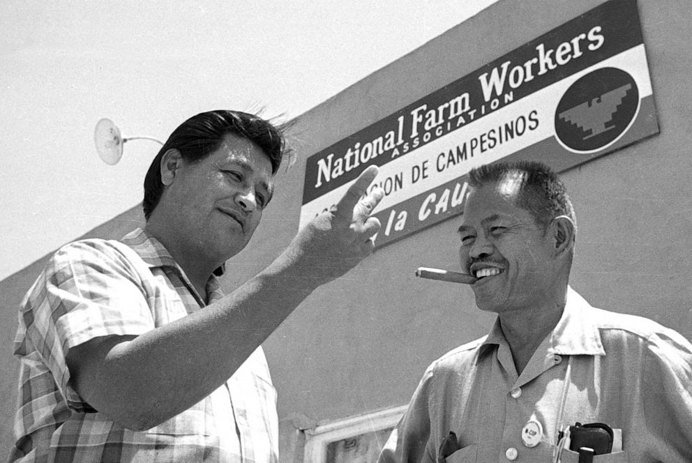 PHOTO: United Farm Workers activists Cesar Chavez, left, and Larry Itliong, talk in front of the AFL-CIO union headquarters in Delano, Calif., July 28, 1967. 