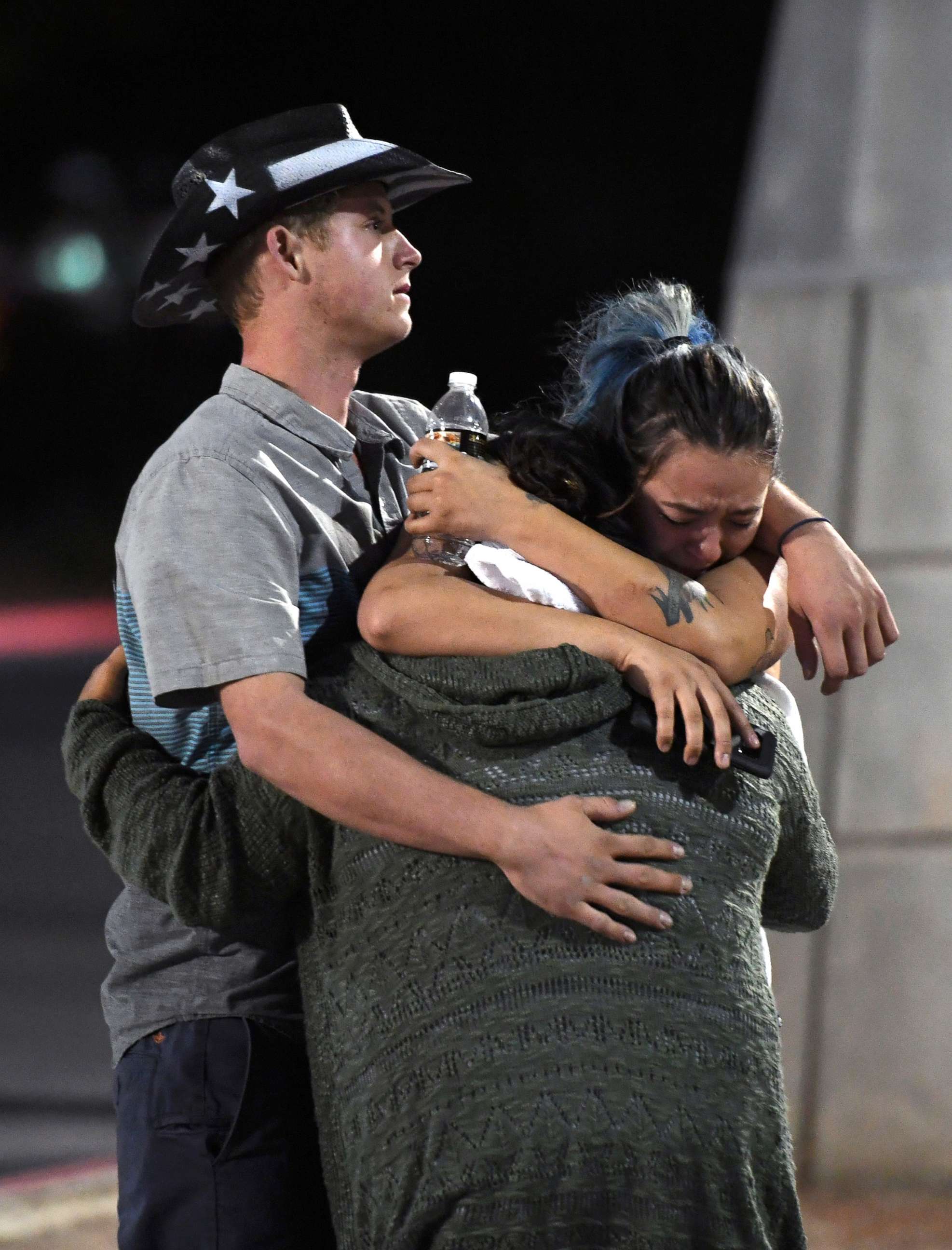 PHOTO: People hug and cry outside the Thomas & Mack Center after a mass shooting at the Route 91 Harvest country music festival, Oct. 2, 2017 in Las Vegas, Nevada. 