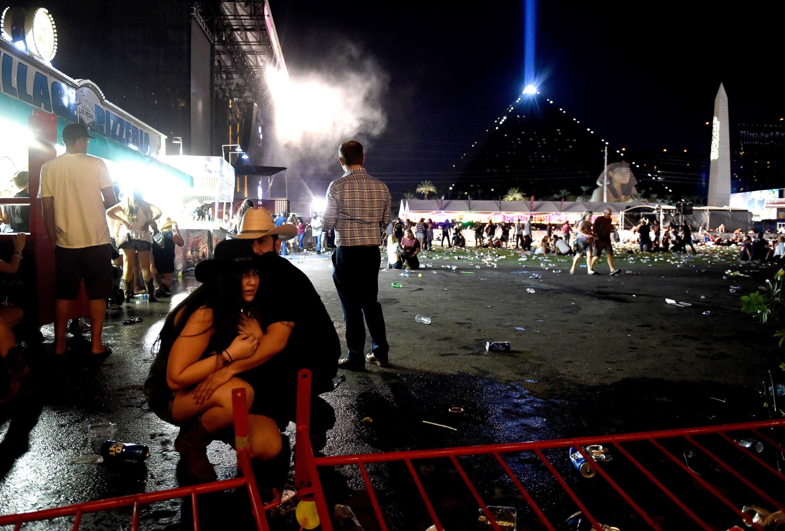 PHOTO: People take cover at the Route 91 Harvest country music festival after  gun fire was heard, Oct. 1, 2017 in Las Vegas, Nevada.  