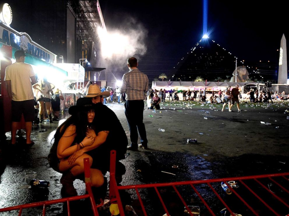 PHOTO: People take cover at the Route 91 Harvest country music festival after gun fire was heard, Oct. 1, 2017 in Las Vegas, Nevada.