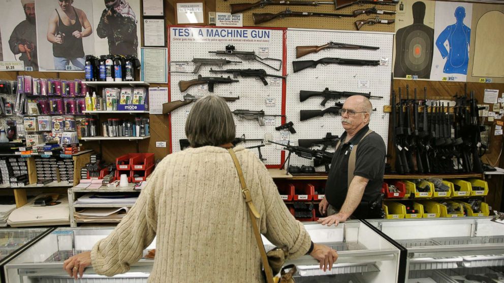 Janet Goff, a visitor from Cardiff, Calif., looks over a selection of machine guns inside The Gun Store in Las Vegas, March 29, 2006. 