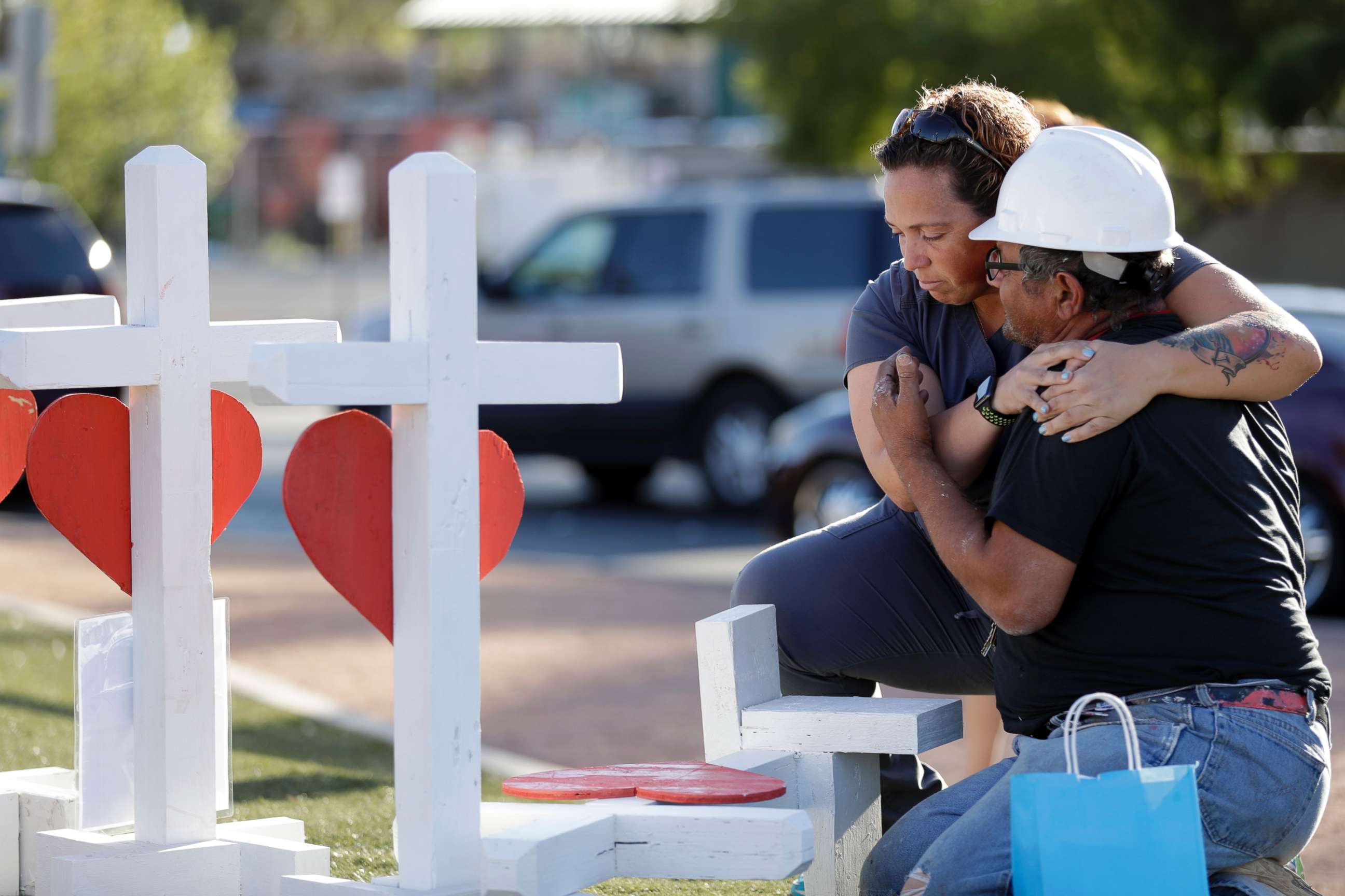 PHOTO: Ebony Saunders, left, hugs Greg Zanis in front of his memorial crosses, Oct. 5, 2017, in Las Vegas. 