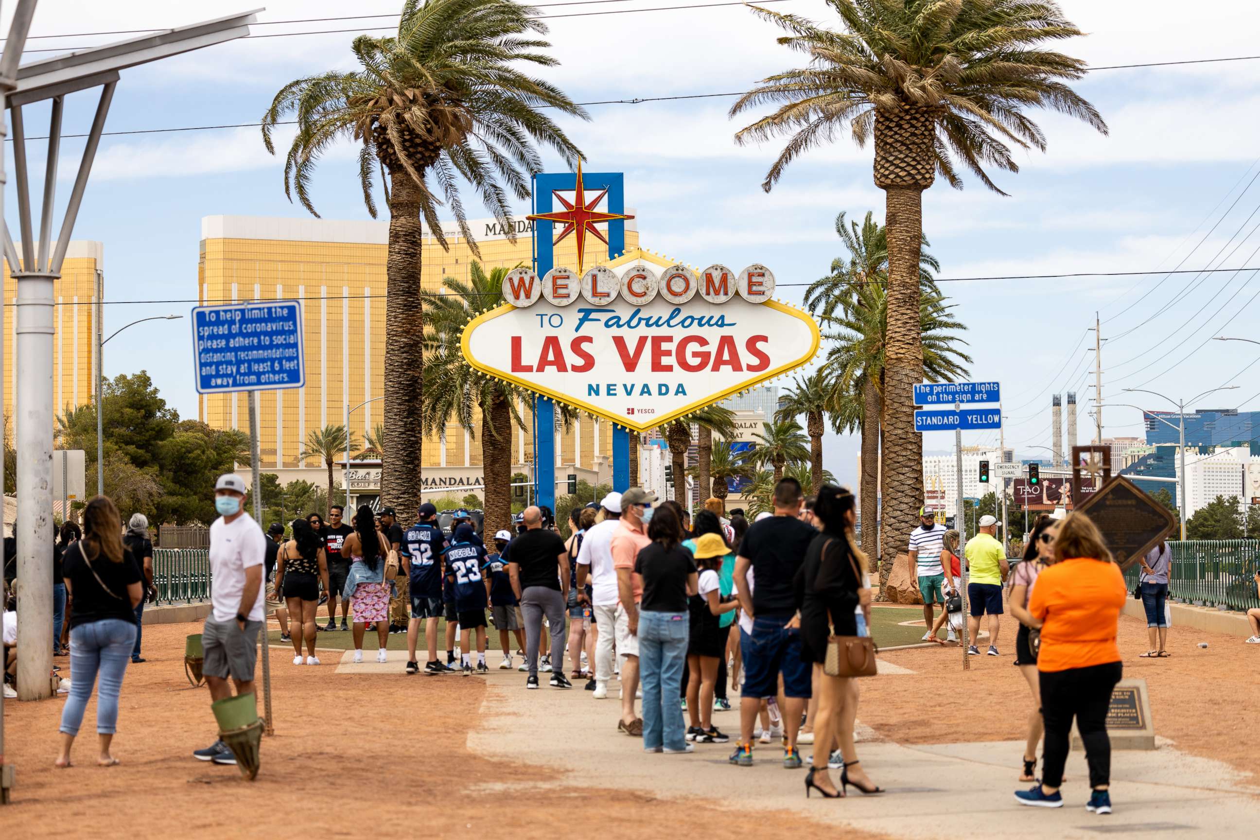 PHOTO: Tourists wait in line to take photographs with the "Welcome to Fabulous Las Vegas" sign in Las Vegas, May 1, 2020.