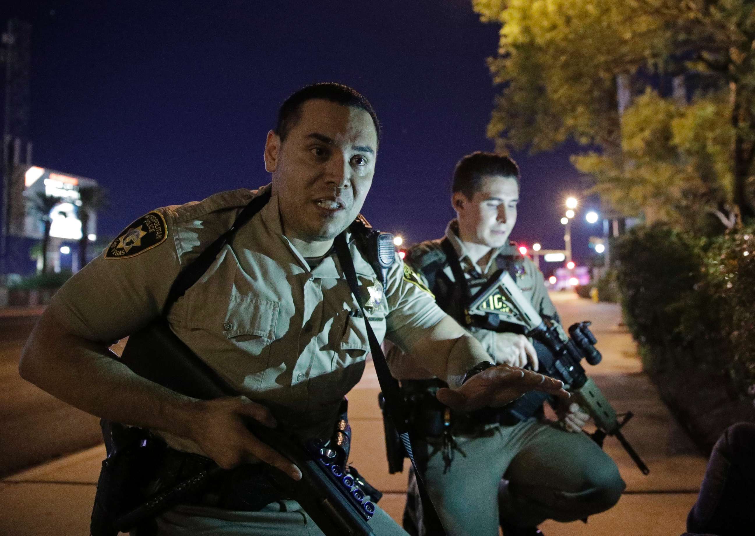 PHOTO: Police officers advise people to take cover near the scene of a shooting near the Mandalay Bay resort and casino on the Las Vegas Strip in Las Vegas, Oct. 1, 2017.