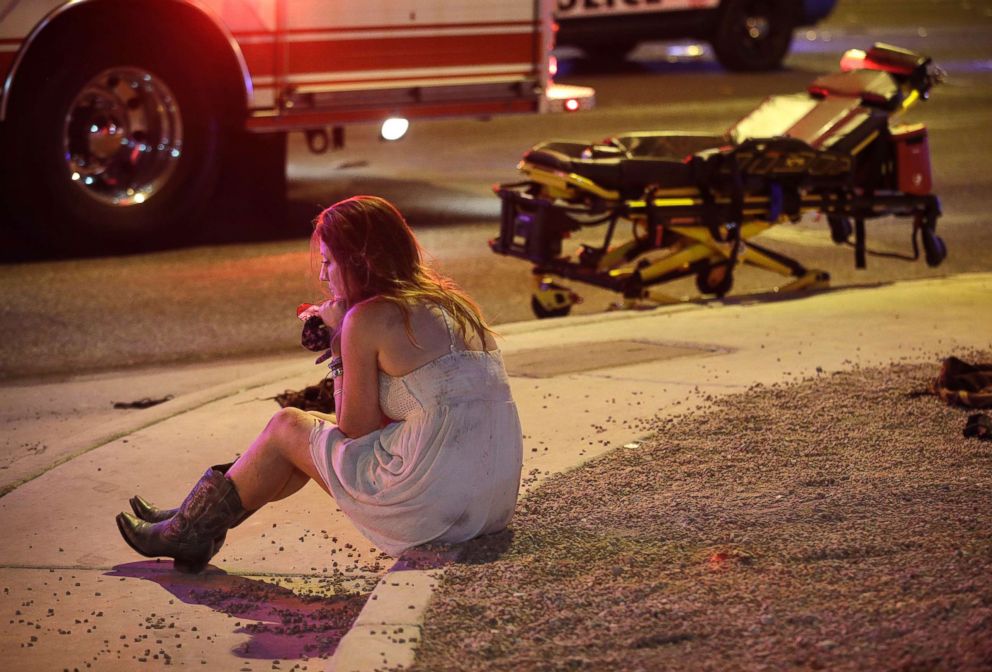 PHOTO: A woman sits on a curb at the scene of a shooting outside of a music festival along the Las Vegas Strip, Oct. 2, 2017, in Las Vegas.
