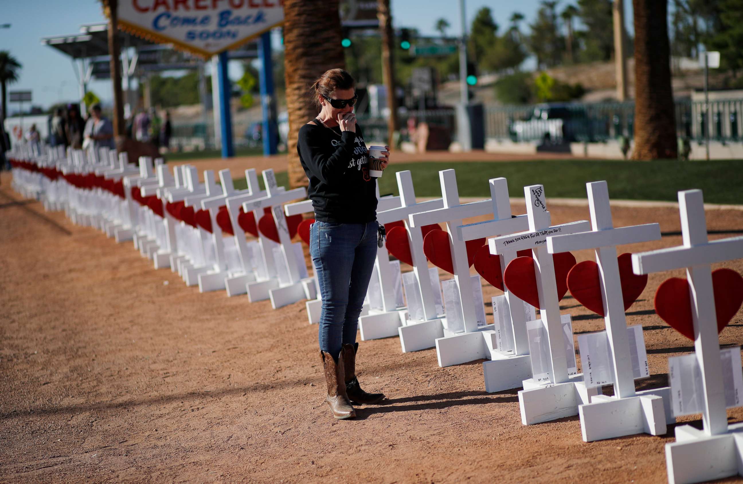 PHOTO: Jill Hale stands at a makeshift memorial for shooting victims, Tuesday, Oct. 1, 2019, in Las Vegas, on the anniversary of the mass shooting two years earlier. 