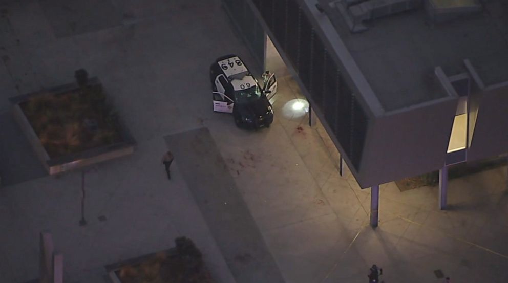 PHOTO: Law enforcement look at a vehicle at the Metro station in Compton where two Los Angeles sheriff's deputies were shot in an ambush on Saturday, Sept. 12, 2020.