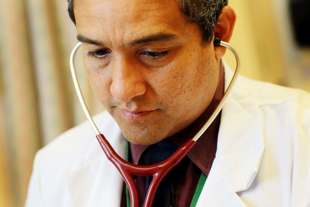 PHOTO: Dr. Olveen Carrasquillo, Chief of General Internal Medicine University of Miami, listens with a stethoscope as he conducts a checkup at the University of Miami's Miller School of Medicine, Jan. 28, 2011.