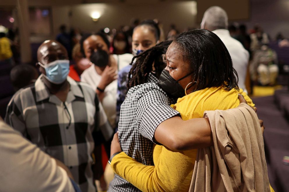 PHOTO: Latisha Rogers, right, a clerk at Tops market who called 911 when when a gunman opened fire at the store, is consoled during services at True Bethel Baptist Church on May 15, 2022 in Buffalo, N.Y.