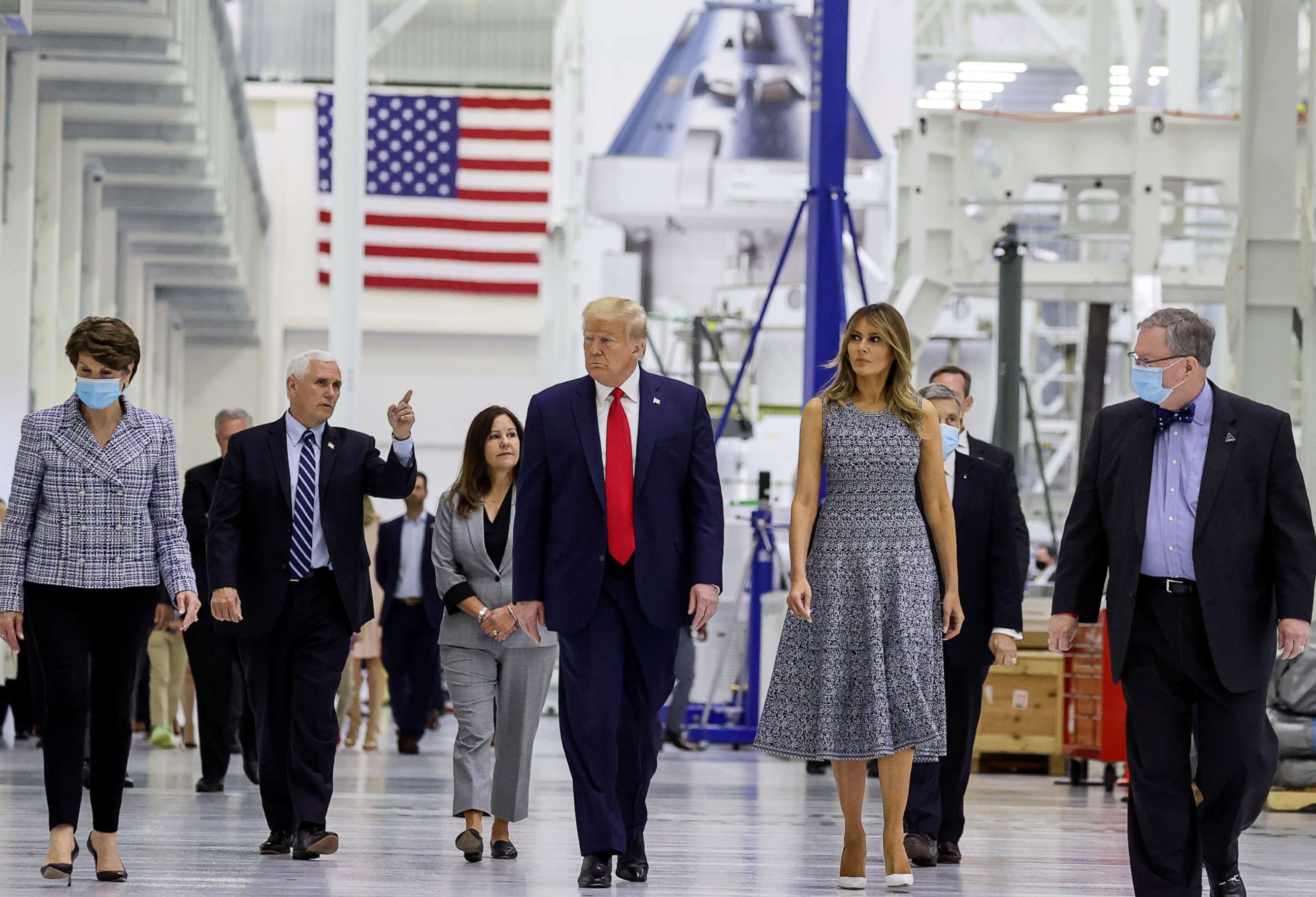 PHOTO: U.S. President Donald Trump listens to Vice President Mike Pence as they tour the Neil Armstrong Operations and Checkout Facility in Cape Canaveral, Florida, U.S., May 27, 2020.