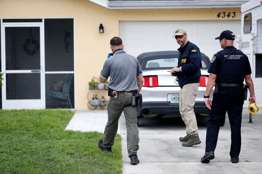 PHOTO: FBI agents talks with a North Port officer while they collect evidence from the home of Brian Laundrie, Sept. 20, 2021, in North Port, Fla.