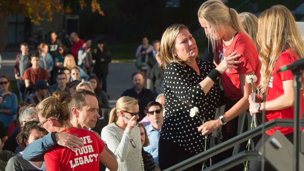 PHOTO: Lauren McCluskey's parents, Matt and Jill McCluskey, hug some of their daughter's teammates after a vigil for their daughter on Oct. 24, 2018 in Salt Lake City.