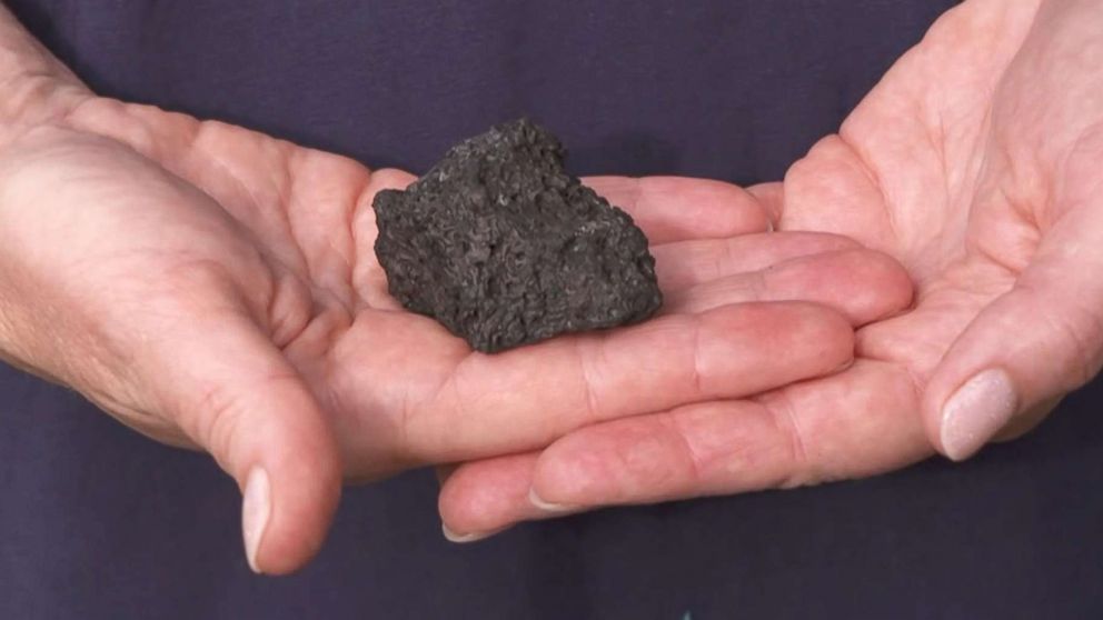 PHOTO: Dawn Li holds a lava rock that hit her as she stands with her family describing the lava bomb that struck their tour boat on July 16, 2018 in Hawaii.