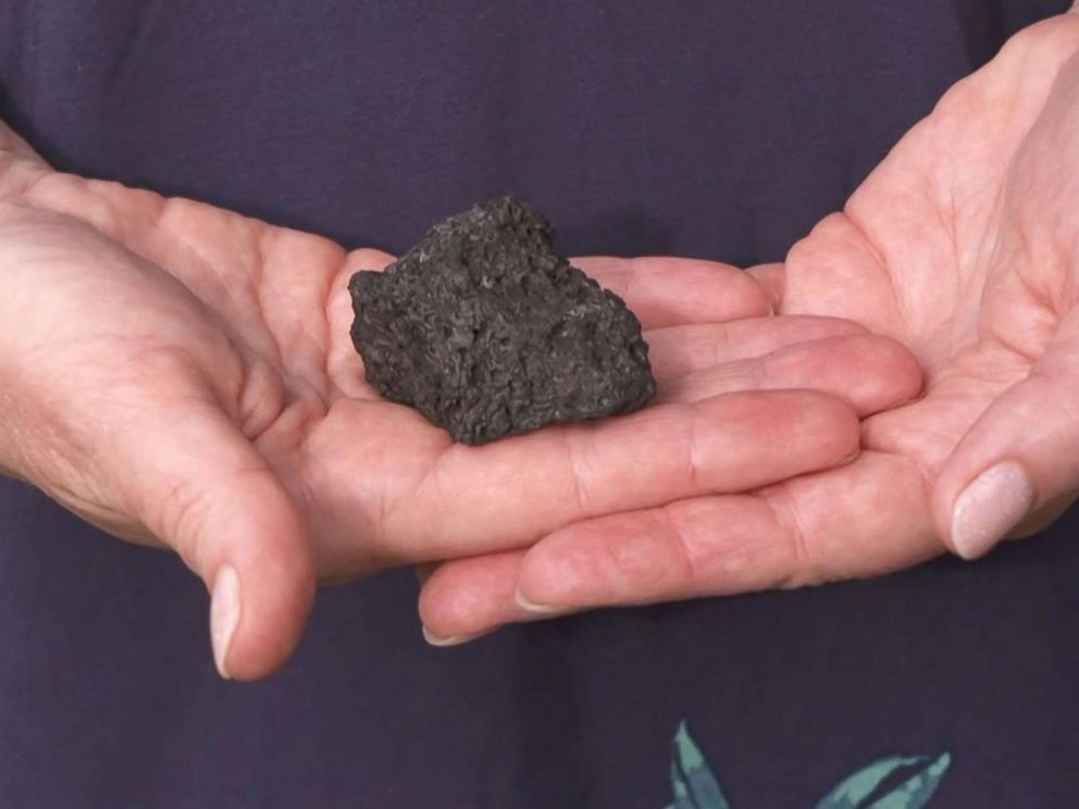 PHOTO: Dawn Li holds a lava rock that hit her as she stands with her family describing the lava bomb that struck their tour boat on July 16, 2018 in Hawaii.