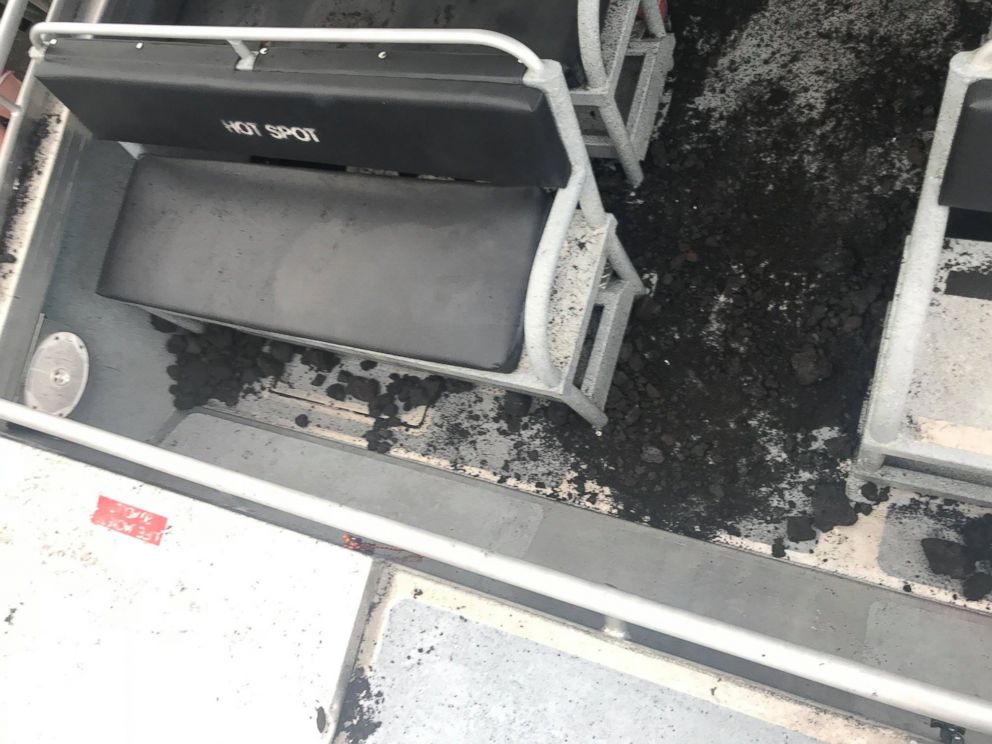 Ash and rocks lie on the bottom of the tour boat after a lava bomb crashed through the roof, seriously injuring one woman on Monday, July 16, 2018.
