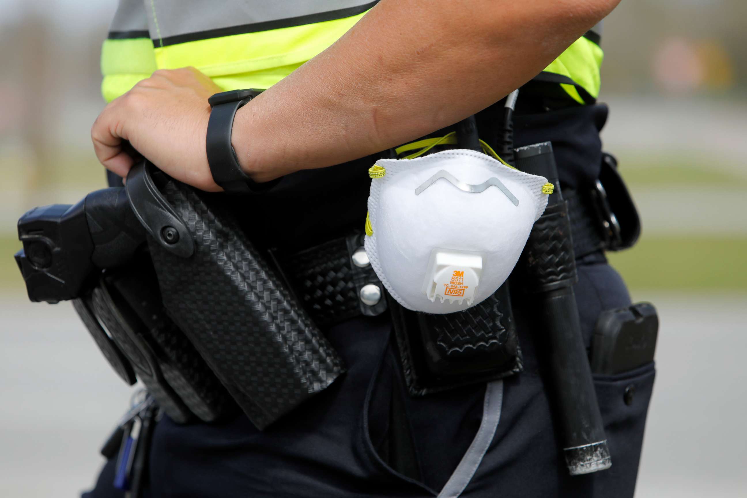 PHOTO: A North Charleston police officer carries a protective mask around his gun belt while working traffic at Roper St. Francis' North Charleston office, March 16, 2020, in North Charleston, S.C.