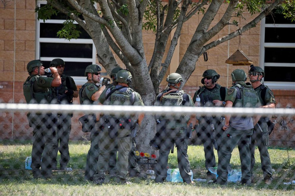 PHOTO: Members of law enforcement stand outside Robb Elementary School after a shooting, May 24, 2022, in Uvalde, Texas. 