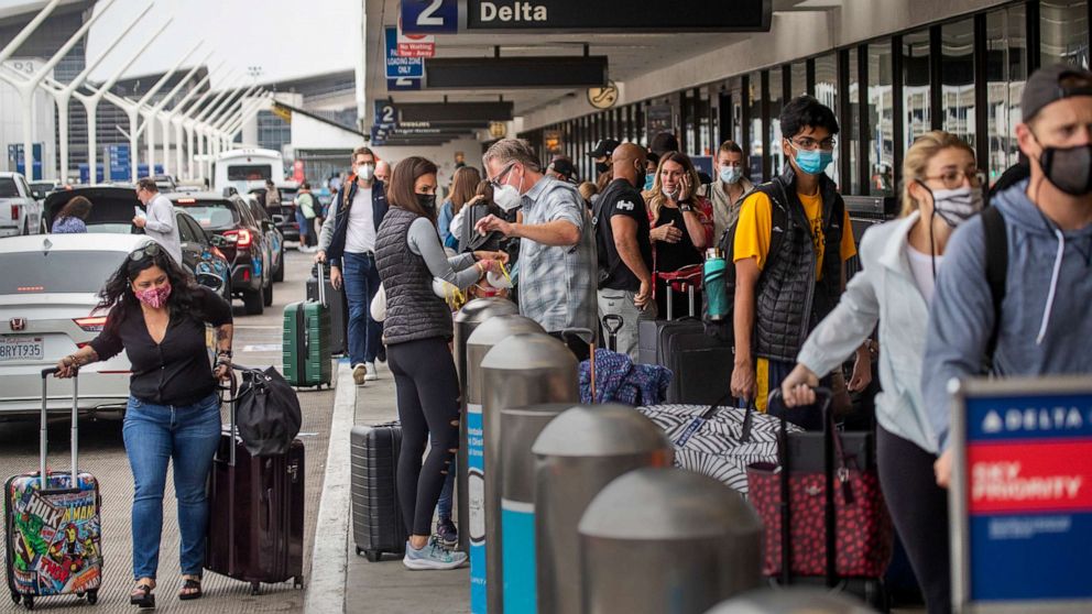 PHOTO: A crowd of travelers wait in line to check in for their flights at LAX in Los Angeles, May 28, 2021.