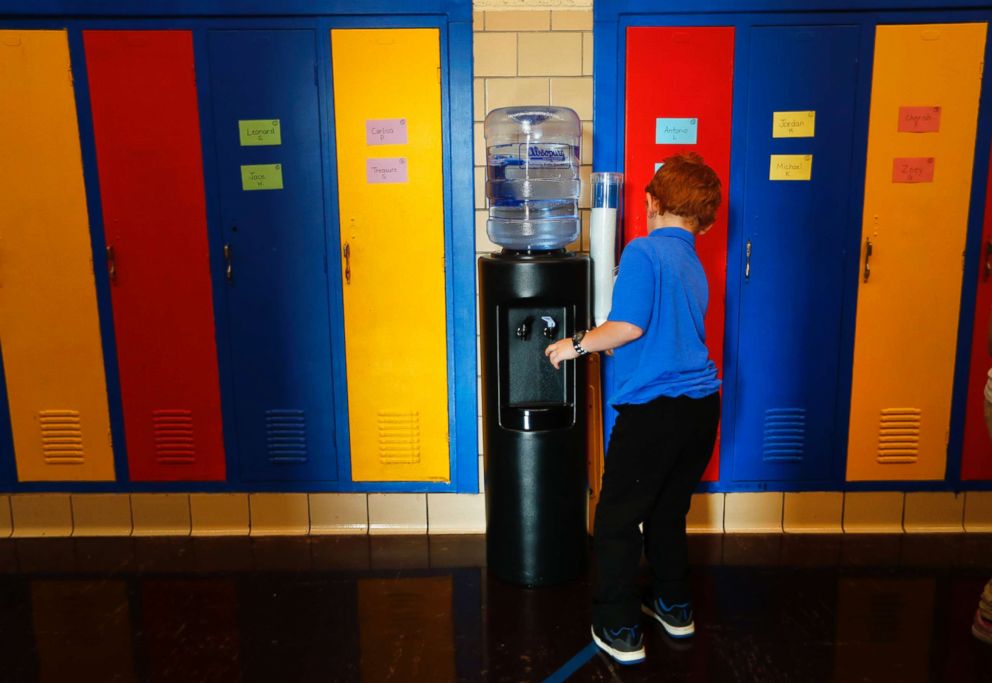 PHOTO: A student gets water from a cooler in the hallway at Gardner Elementary School in Detroit, Sept. 4, 2018. 