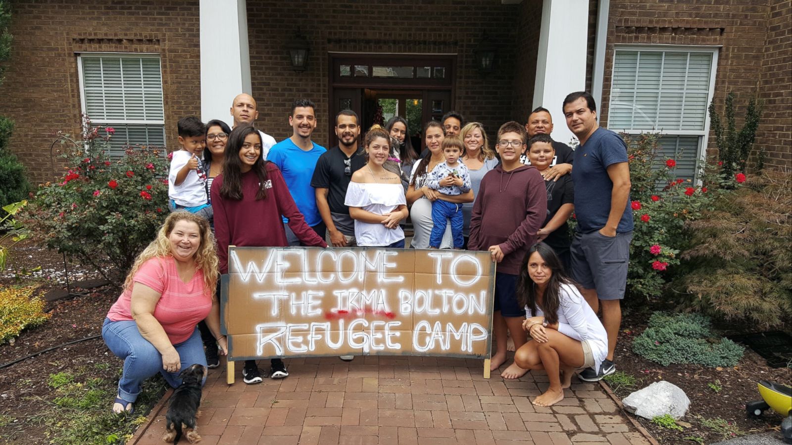 PHOTO: Leah Bolton (standing, fifth from right) opened her home in Tennessee to 26 people evacuating from 2017's Hurricane Irma.