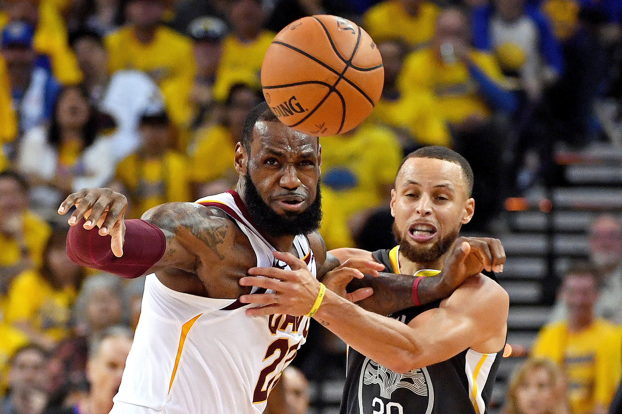 PHOTO: Golden State Warriors guard Stephen Curry (30) and Cleveland Cavaliers forward LeBron James (23) go for a loose ball during the second quarter in game one of the 2018 NBA Finals at Oracle Arena, June 3, 2018, Oakland, Calif.