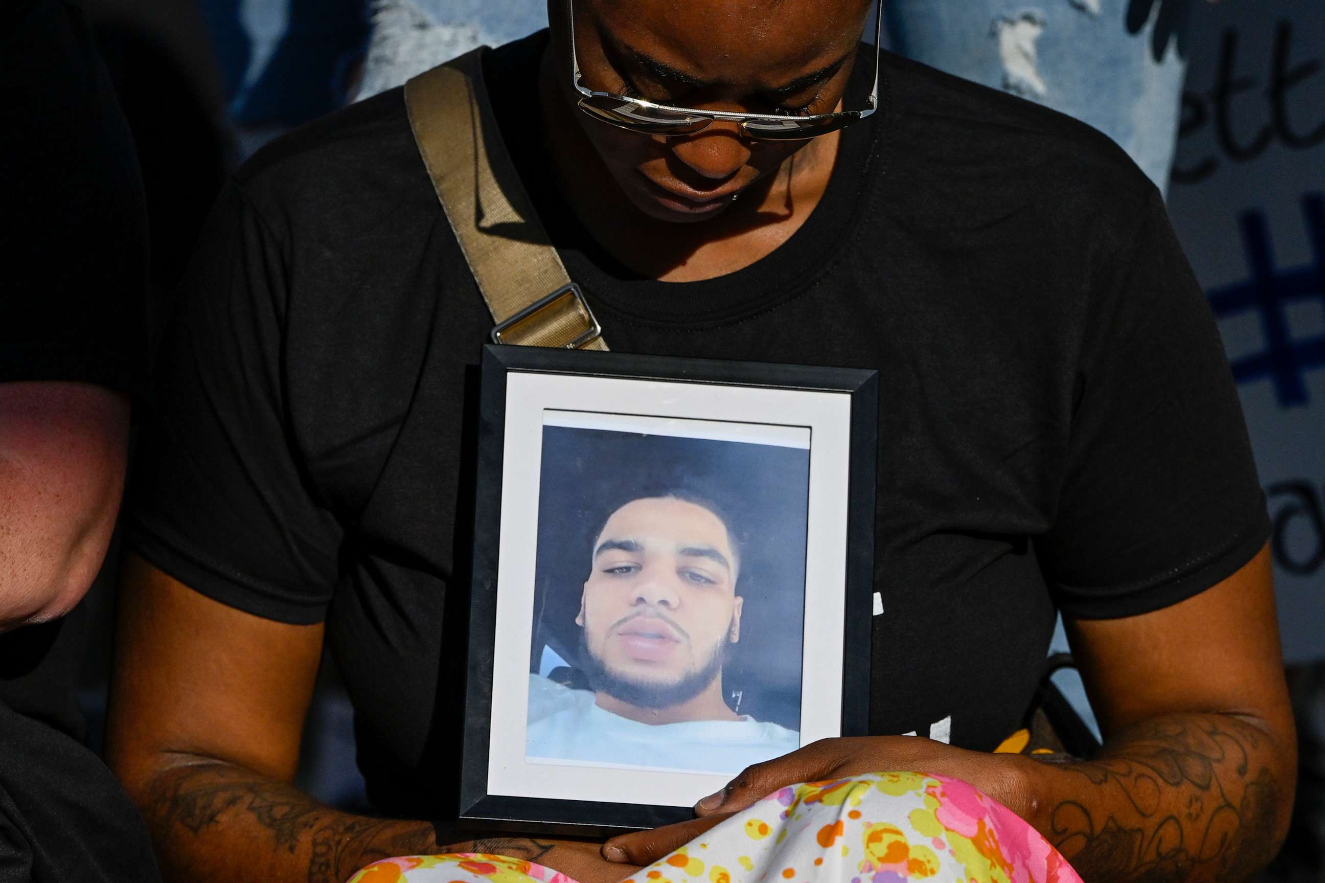 PHOTO: The girlfriend of Donovan Lewis holds a picture of him during a rally at the Columbus Division of Police Headquarters, Sept. 2, 2022, in Columbus, Ohio.