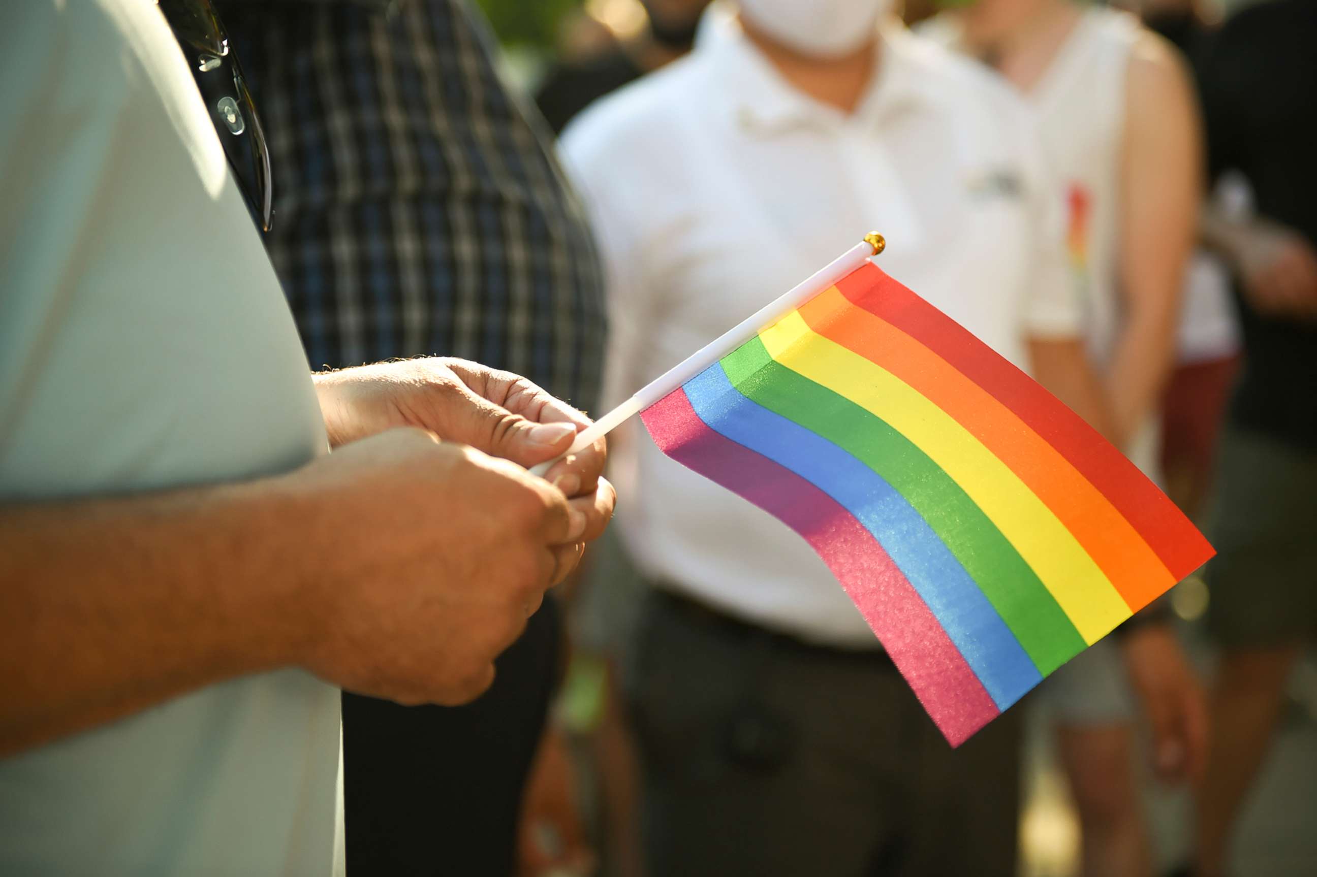 PHOTO: A person holds a Pride flag during a celebration of Pride month in Reading, Pa., June 12, 2020.