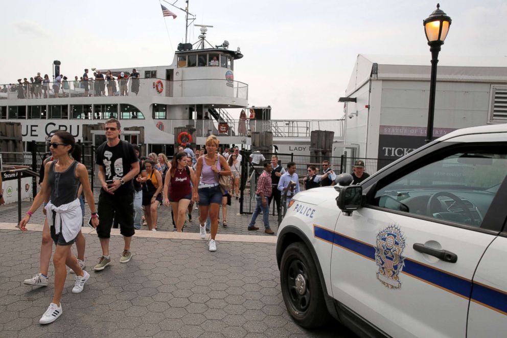 PHOTO: A police vehicle is parked by a ferry of people being evacuated after a fire broke out near the Statue of Liberty on Liberty Island in New York, Aug. 27, 2018.