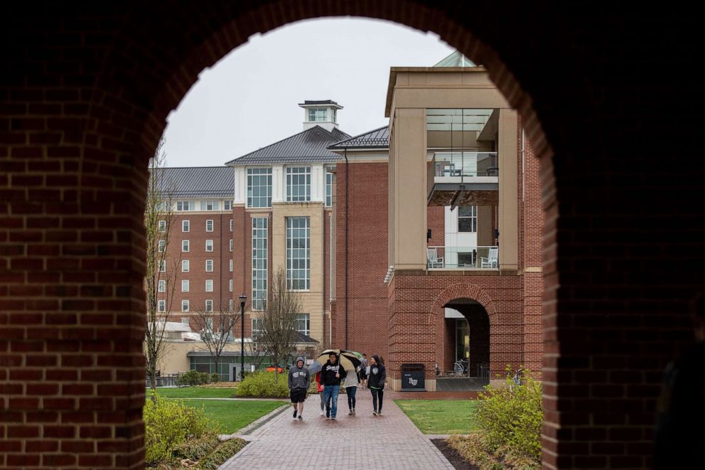 PHOTO: Students at Liberty University in Lynchburg, Va., congregate while walking around on the campus, March 31, 2020.