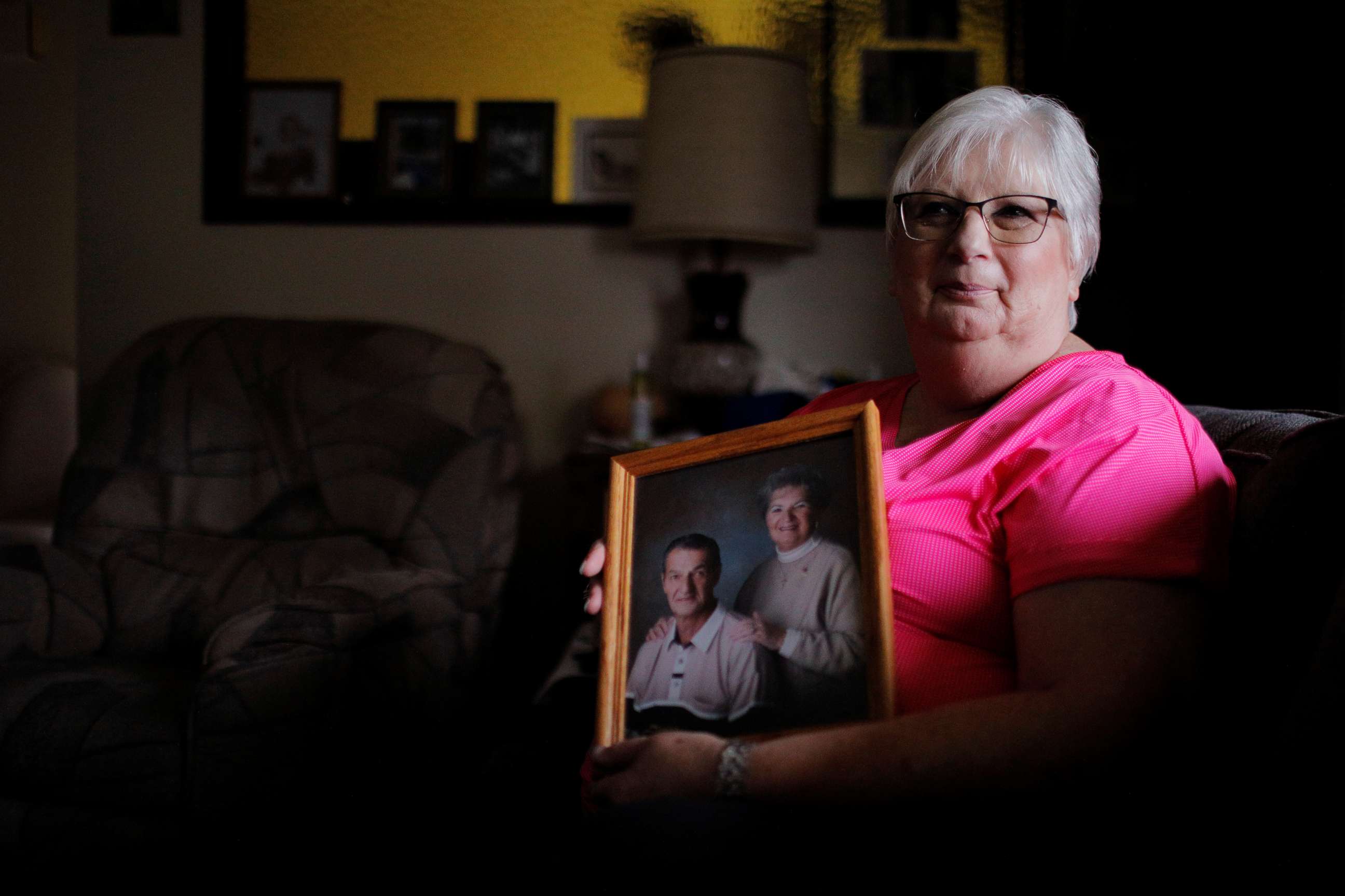 PHOTO: Debbie de los Angeles, holds a photograph of her mother Twilla Morin who died from coronavirus at the Life Care Center of Kirkland, while posing for a portrait at her home in Monroe, Washington, March 23, 2020. 