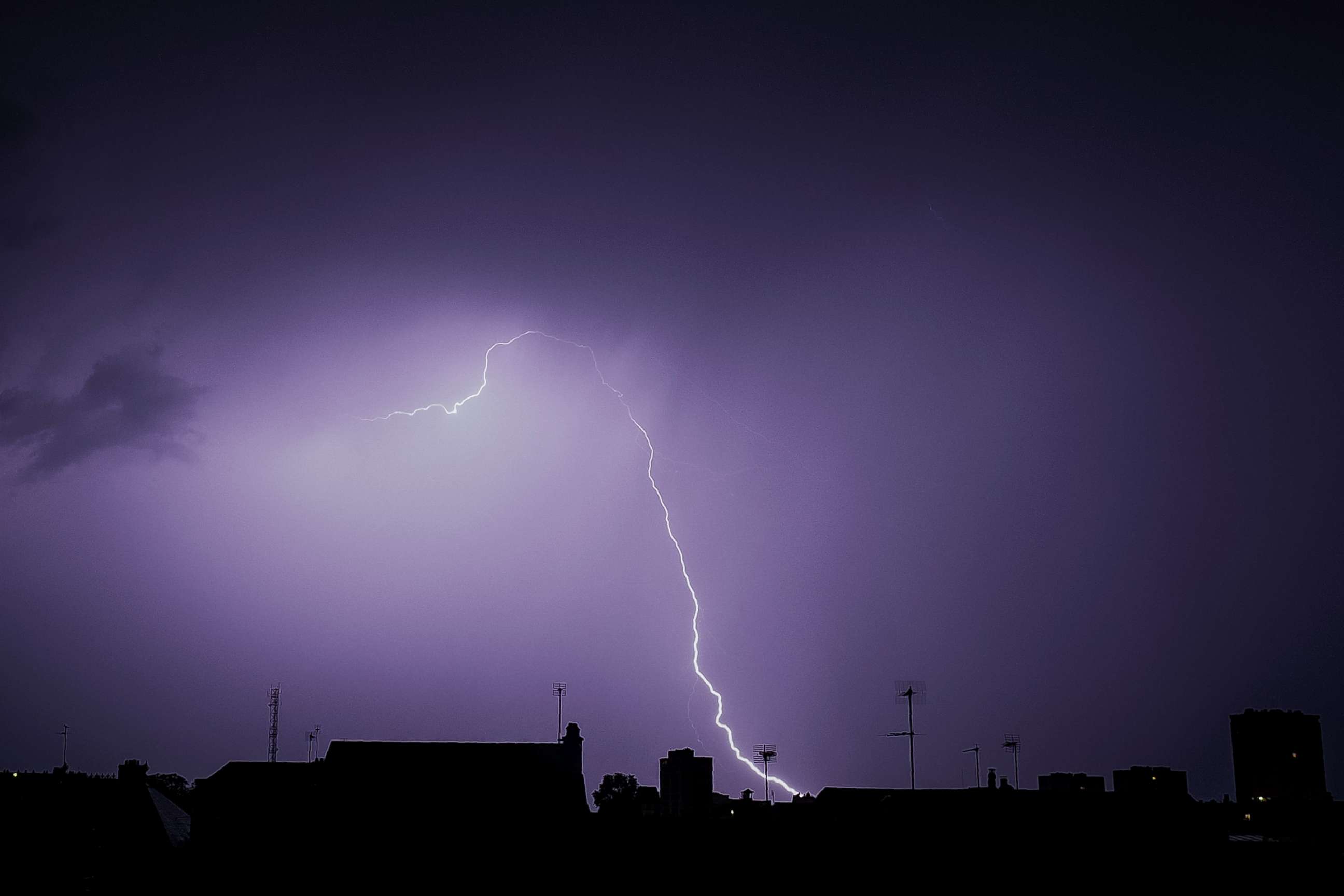 PHOTO: Lightning is  seen during a storm over the roofs in Tours, France, Aug. 29, 2018.