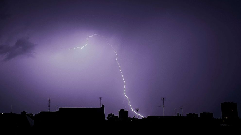 Lightning is  seen during a storm over the roofs in Tours, France, Aug. 29, 2018.