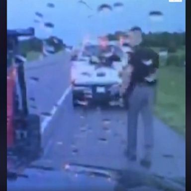 Dramatic dashcam footage shows the moment lightning strikes close to the trooper as he helps a driver on the side of the highway.